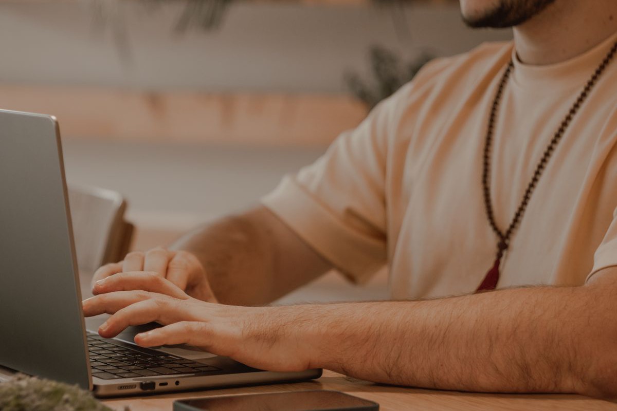 A man working at a laptop in a home office