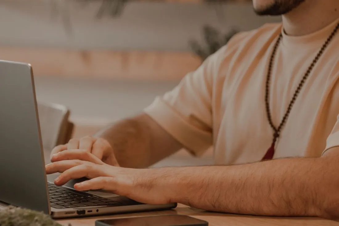 A man working at a laptop in a home office