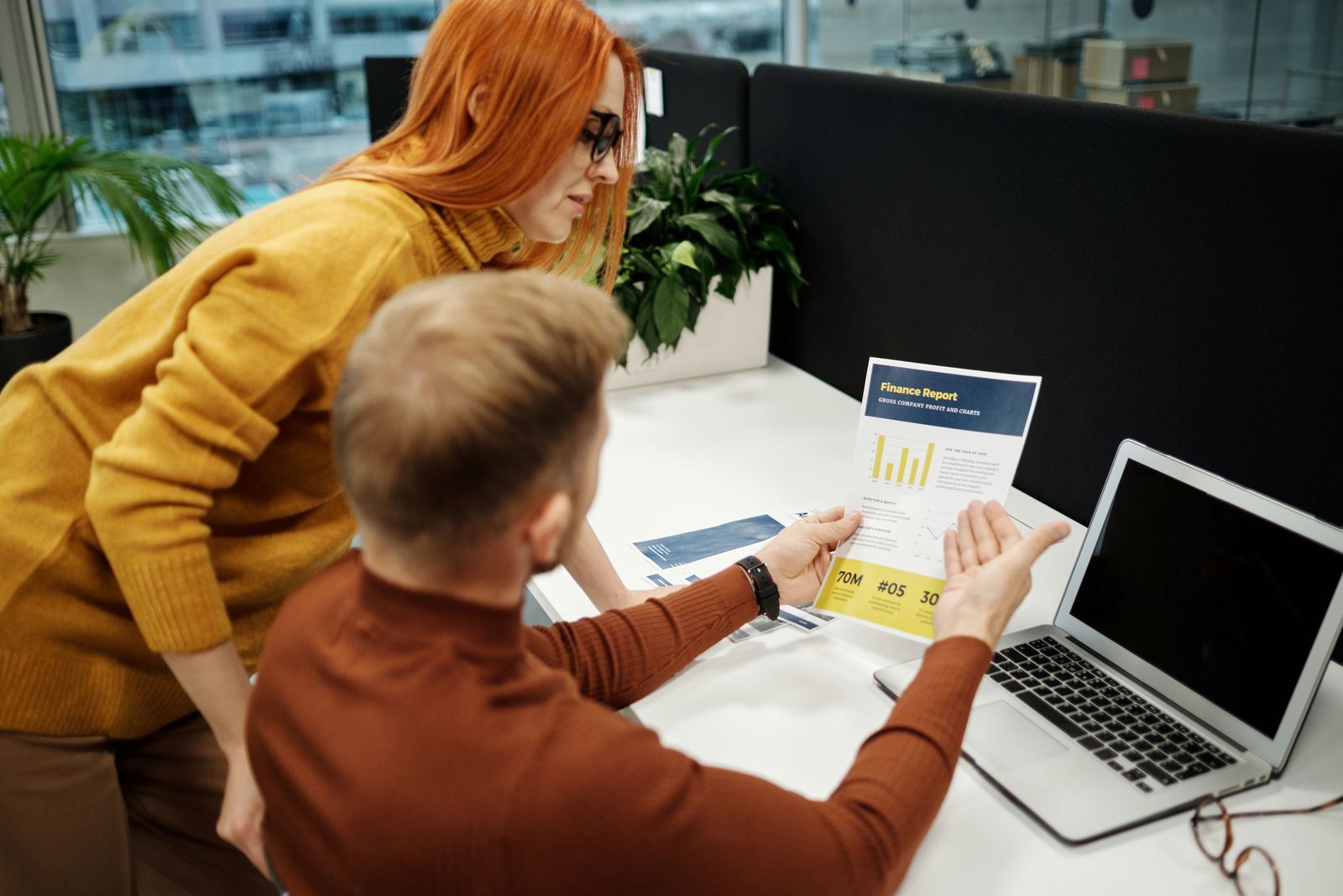 Two people reviewing a document together at a desk
